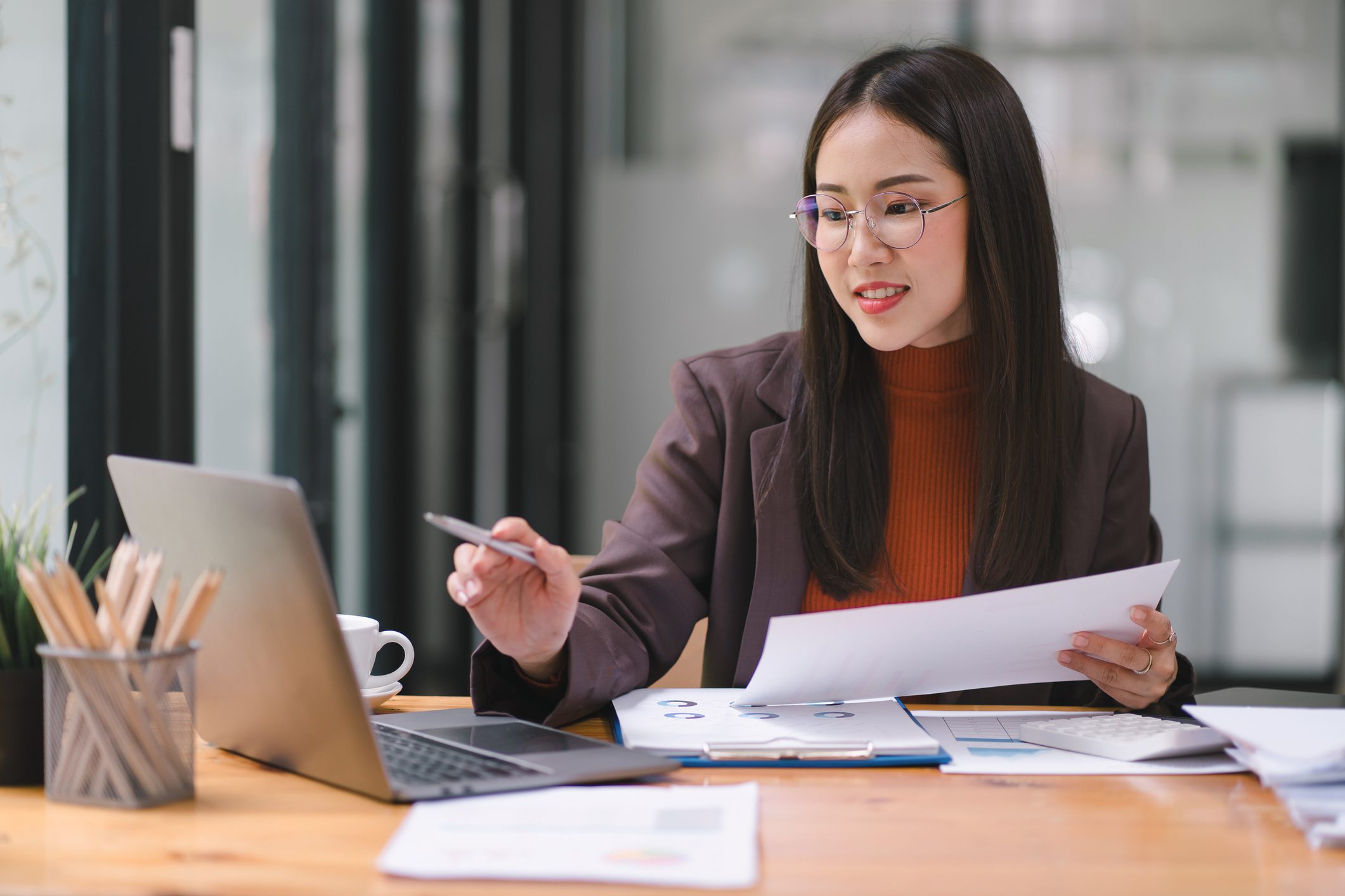 Businesswoman reviewing financial documents.